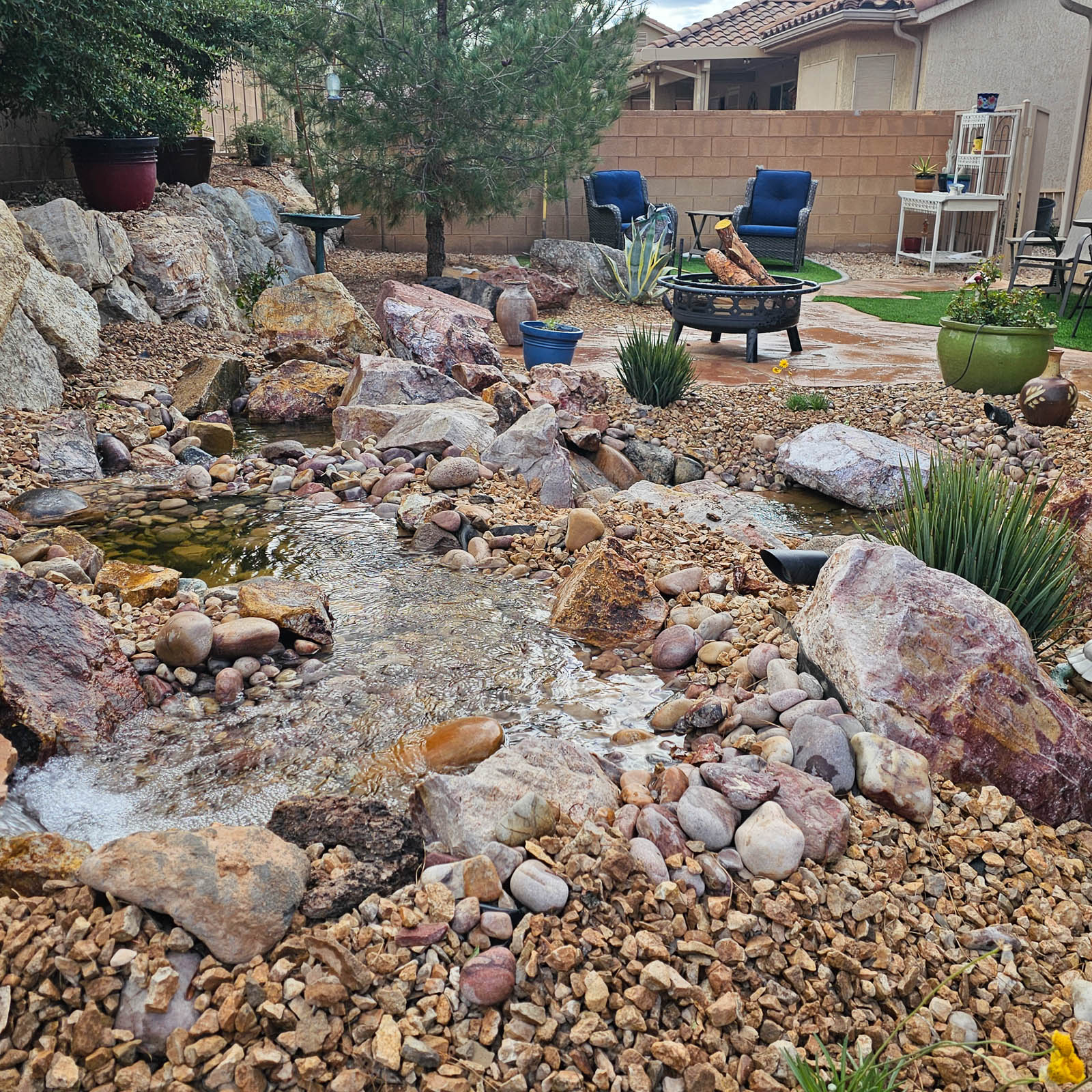 Rock stream and pond with patio seating